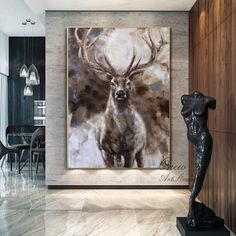 a deer painting hanging on the wall next to a statue in a room with marble flooring