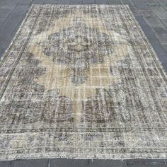 an old rug is laying on the ground