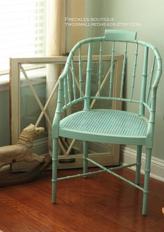 a blue chair sitting on top of a hard wood floor