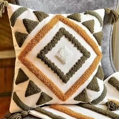 a decorative pillow with tassels on it