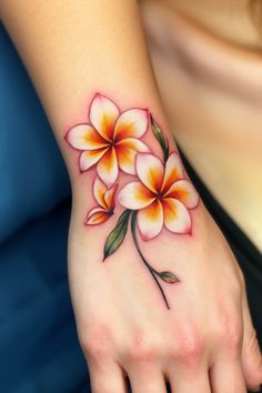 a woman's hand with a flower tattoo on it