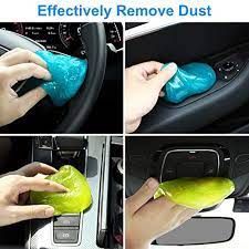 there is a person cleaning the inside of a car with a green cloth and sponge