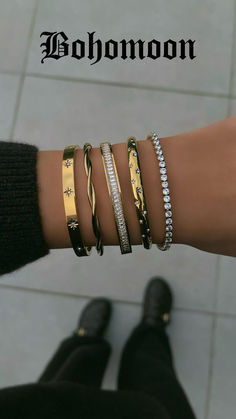 Image is showing a model wearing a Bohomoon bracelet stack in gold with CZ detailing.