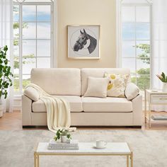 a living room scene with focus on the couch and coffee table in the foreground