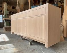 a large wooden cabinet sitting inside of a building