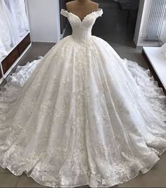 a white wedding dress on display in a store