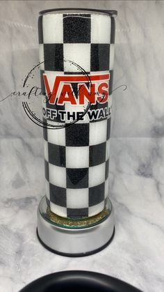 a black and white checkered glass sitting on top of a counter