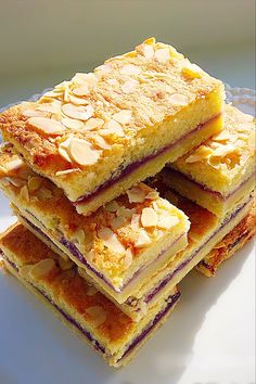 four pieces of cake sitting on top of a white plate