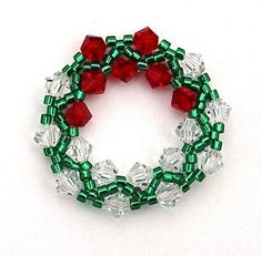 a green and red beaded bracelet on a white background