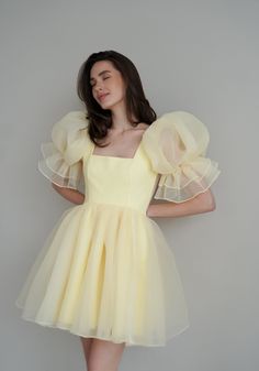 Introducing the Britney Dress in a delightful light yellow: a stunning creation crafted from delicate bubble organza. This lightweight dress features an elegant silhouette with a voluminous floating skirt that moves gracefully with every step. The charming puff sleeves add a whimsical touch, making it perfect for any s Organza Frocks, Short Frocks, Short Frock, Simple Frocks, Frock For Women, Fancy Dresses Long, Quick Outfits, Look Vintage