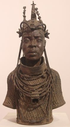 a statue of a woman wearing an elaborate headdress