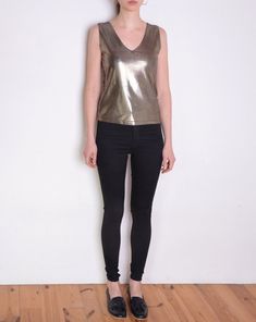 Cool vintage blouse made of unique fabric: shiny metallic textile in color that looks like a mix of silver and gold. Texture of tiny dots on almost invisible black background. Sleeveless, v neckline. Era: 90's, brand Hennes Fabric: 80% polyamide, 20% elasthane Condition: very good Estimated size: M / L (please, check the measurements) Measurements (measured flat, without stretching. Item is stretchy. Need to be doubled to get the circumference.): Chest: 42 cm / 16,5 inches Length: 55 cm / 21,6 i Fitted Metallic Tank Top For Party Season, V-neck Shimmer Tops For Party Season, Glamorous Shiny Gold Tops, Glamorous Metallic Sleeveless Top, Glamorous Sleeveless Metallic Top, Chic Metallic V-neck Top, Metallic Shiny Disco Top, Glamorous Metallic Stretch Tank Top, Glamorous Stretch Metallic Tank Top