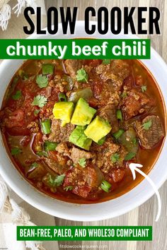 a bowl of slow cooker chunky beef chili with avocado on top