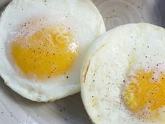 two fried eggs in a bowl on a table