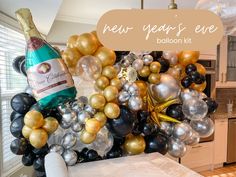 a new year's eve balloon kit with champagne bottle and black and gold balloons