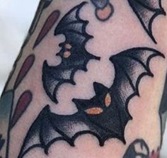 a close up of a person's arm with bats on it