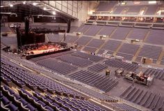 an auditorium with rows of seats and the words mean while at a nickieback concert