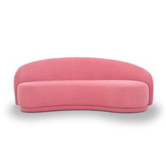 a pink couch sitting on top of a white floor