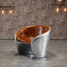 a large metal and wood bowl shaped chair in front of a wall with numbers on it