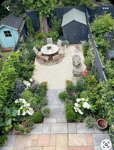 an aerial view of a backyard garden with tables and chairs, surrounded by greenery