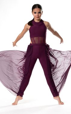 a woman in a purple outfit is dancing