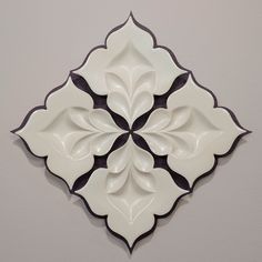 a white and black decorative tile on the wall