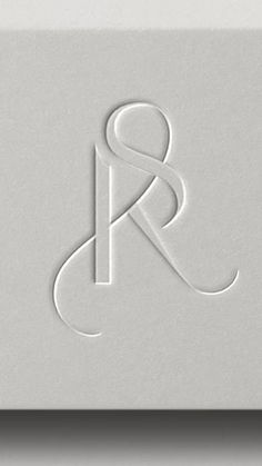 the letter r is made out of white paper and it looks like an abstract logo