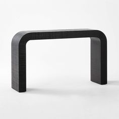 a black and white photo of a modern console table with an arch shaped like a rectangle