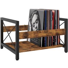 a wooden shelf with cd's and cds in it on top of each other