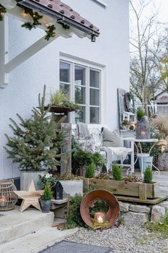 an outdoor patio with potted trees and other decorations