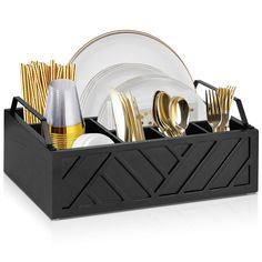 a black tray with silverware and gold forks, knives and spoons in it