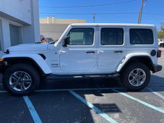 a white jeep parked in a parking lot