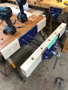 two power tools are sitting on a workbench