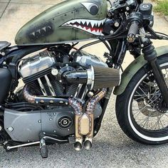 a green and black motorcycle with a shark head on it