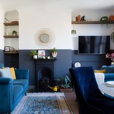 a living room filled with furniture and a flat screen tv mounted on the wall above a fireplace