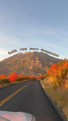 a car driving down a road with mountains in the background and words above it that read, faith can move mountains