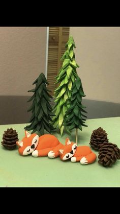 a cake made to look like a sleeping fox and pine cones