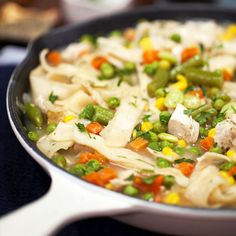 a pan filled with pasta and vegetables on top of a stove