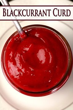 a close up of a bowl of food on a plate with the words blackcurrant curd above it