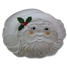 a white santa claus face with holly berry on it's head and nose, sitting in front of a white background