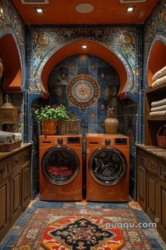 a washer and dryer are in the middle of a room with blue walls