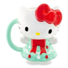 a hello kitty mug with a red bow on it's head and green dress