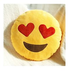 a smiley face pillow with hearts on it