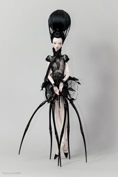 a doll is dressed in black and has long legs with large, slender hair on it