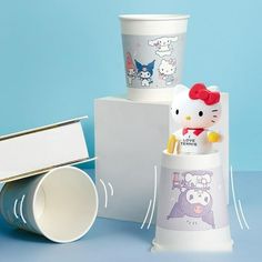 three hello kitty cups are stacked on top of each other, with one cup in the middle