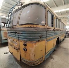 an old bus is parked in a garage