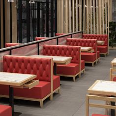 a restaurant with red booths and wooden tables