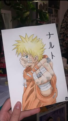 someone holding up a drawing of gohan from the anime naruto on paper