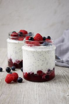 two small jars filled with berries and yogurt