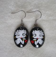 pair of betty boop pattern earrings, pattern size 1.8cm x 2.5cm made by me from the printing of the image to the assembly of the different elements, it is important to me to create beautiful, unique and quality jewelry stainless steel support, quality product, eliminates the risk of allergies Earrings Pattern, Oval Earrings, Ear Jacket, Oval Earring, Earring Patterns, Betty Boop, Quality Jewelry, Made By Me, Assemblage